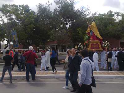 la processione di san Nicola passa davanti alla statua di san Francesco d'Assisi nei pressi del porto